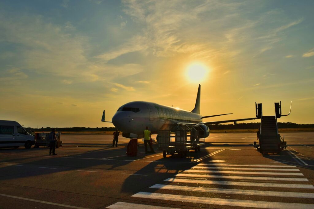 white airplane parked during daytime